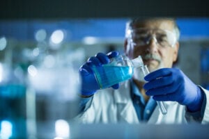 Scientist pouring medicine in test tube